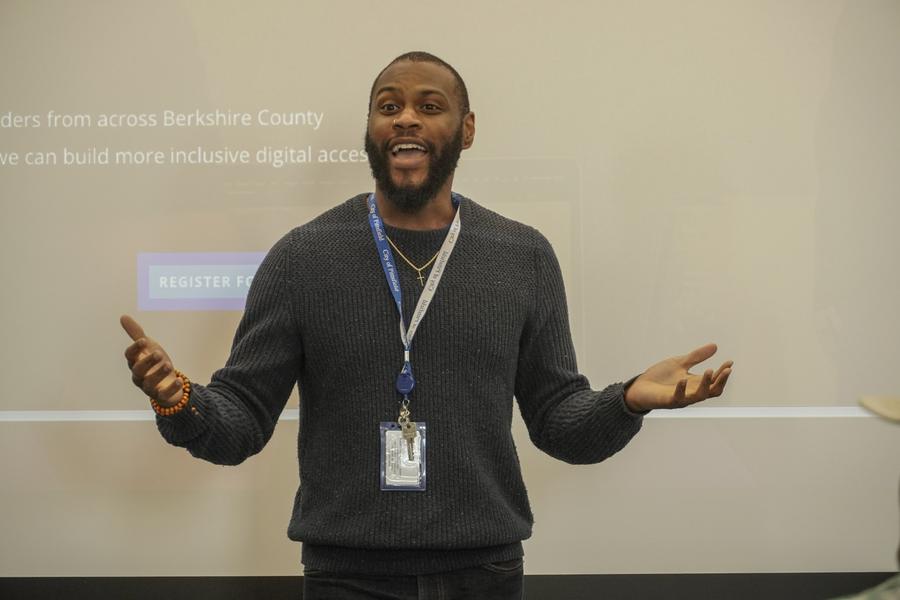 A facilitator presenting with arms open