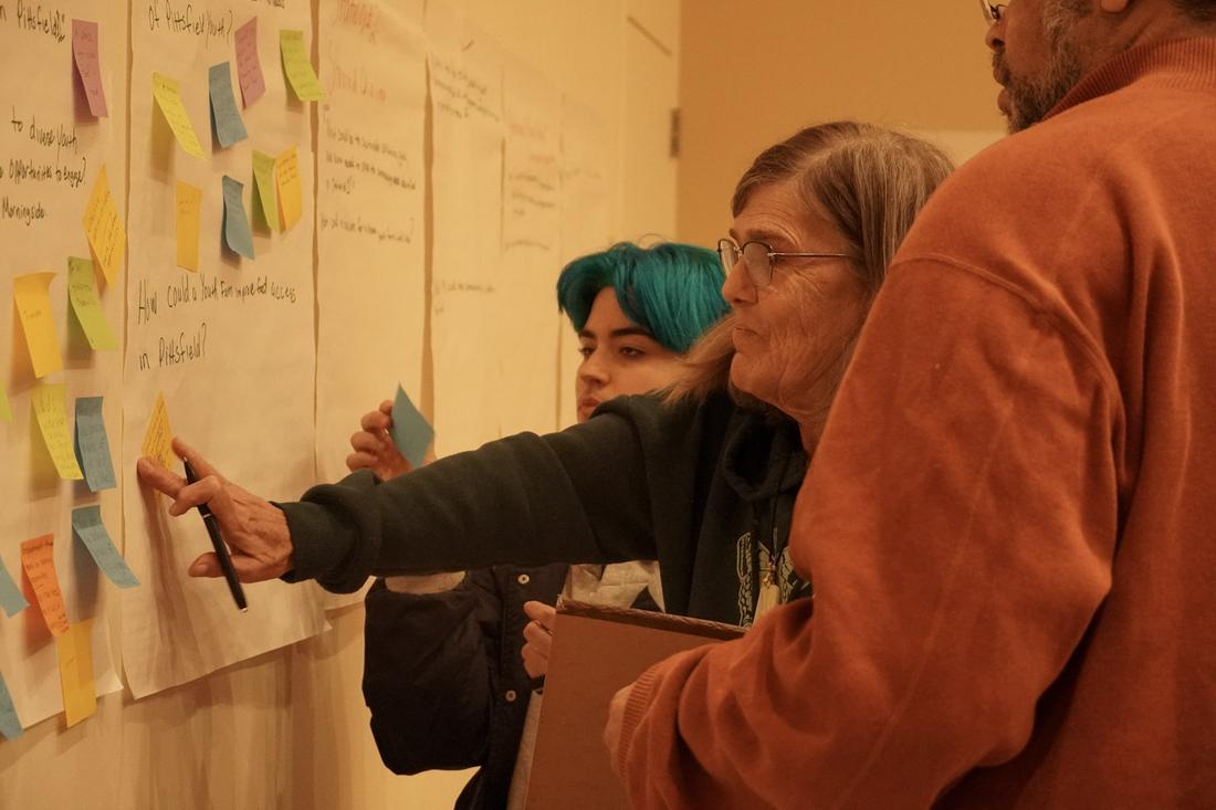 A participant adds a sticky note to the idea wall