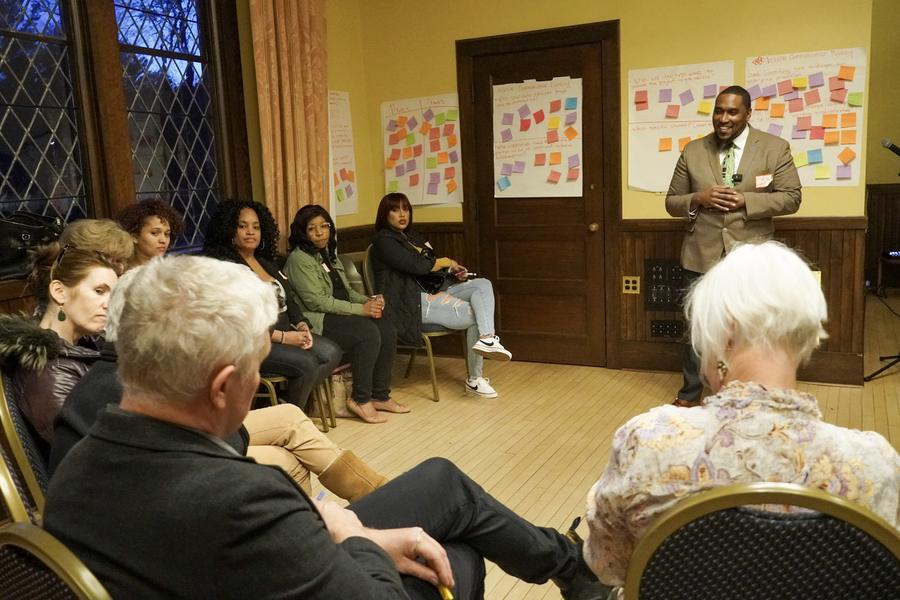 A facilitator leads a seated circle